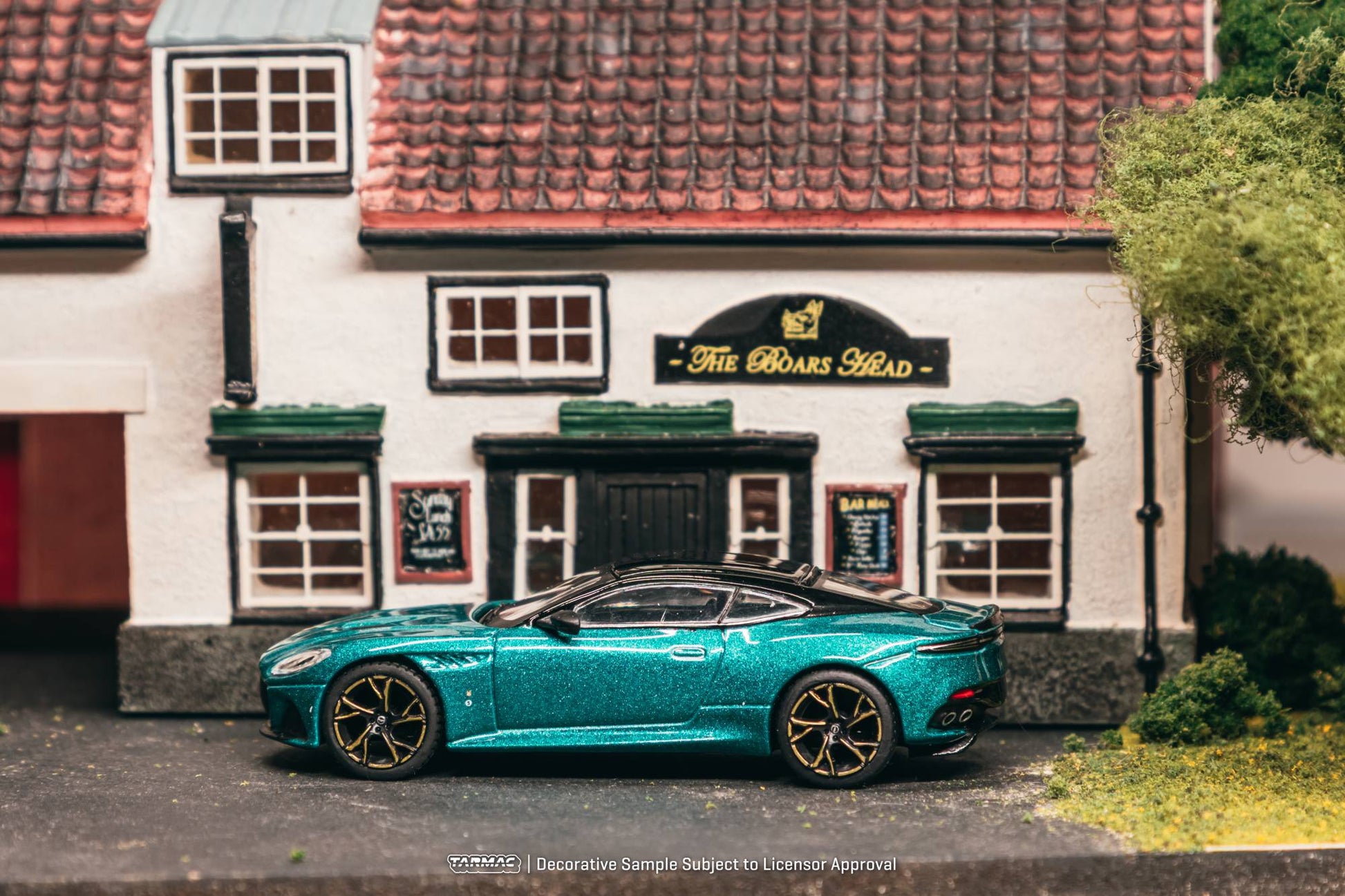 Tarmac Works 1:64 Aston Martin DBS Superleggera green metallic bronze accents diecast model. Side