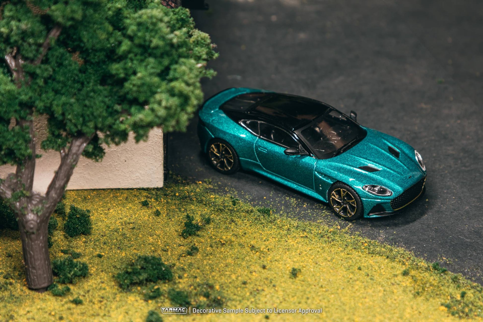 Tarmac Works 1:64 Aston Martin DBS Superleggera green metallic bronze accents diecast model. Top