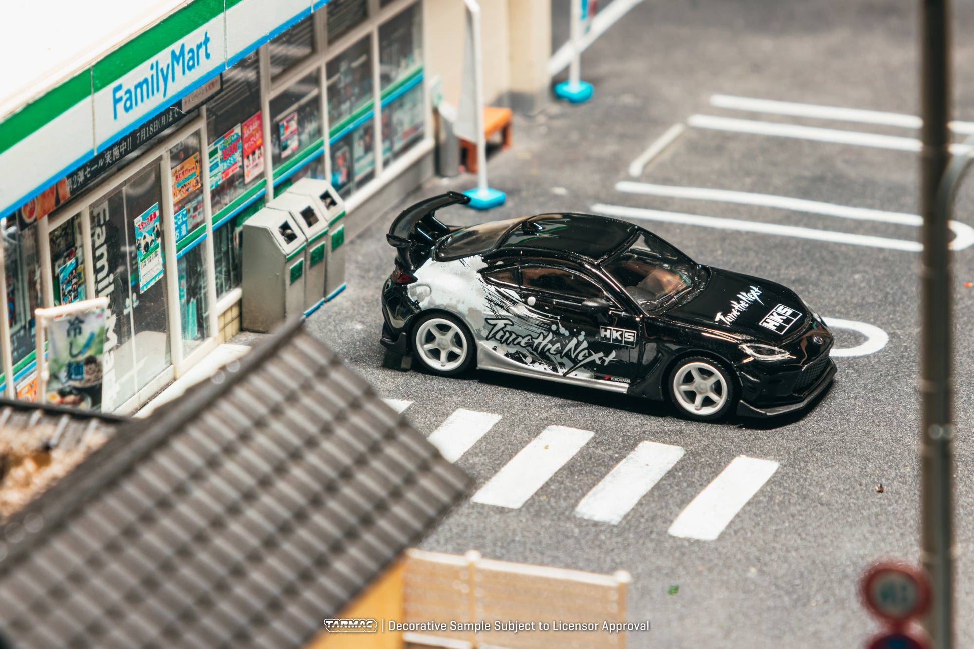 Tarmac Works 1:64 Toyota GR86 HKS black Tune the Next livery white wheels diecast model. Top