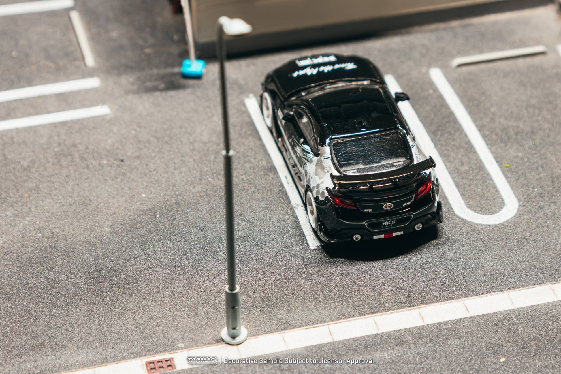 Tarmac Works 1:64 Toyota GR86 HKS black Tune the Next livery white wheels diecast model. Back