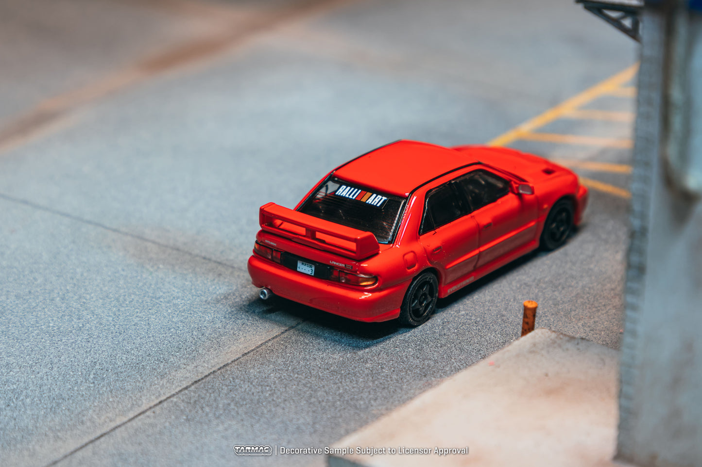 Tarmac Works Global64 Mitsubishi Lancer GSR Evolution III in red.