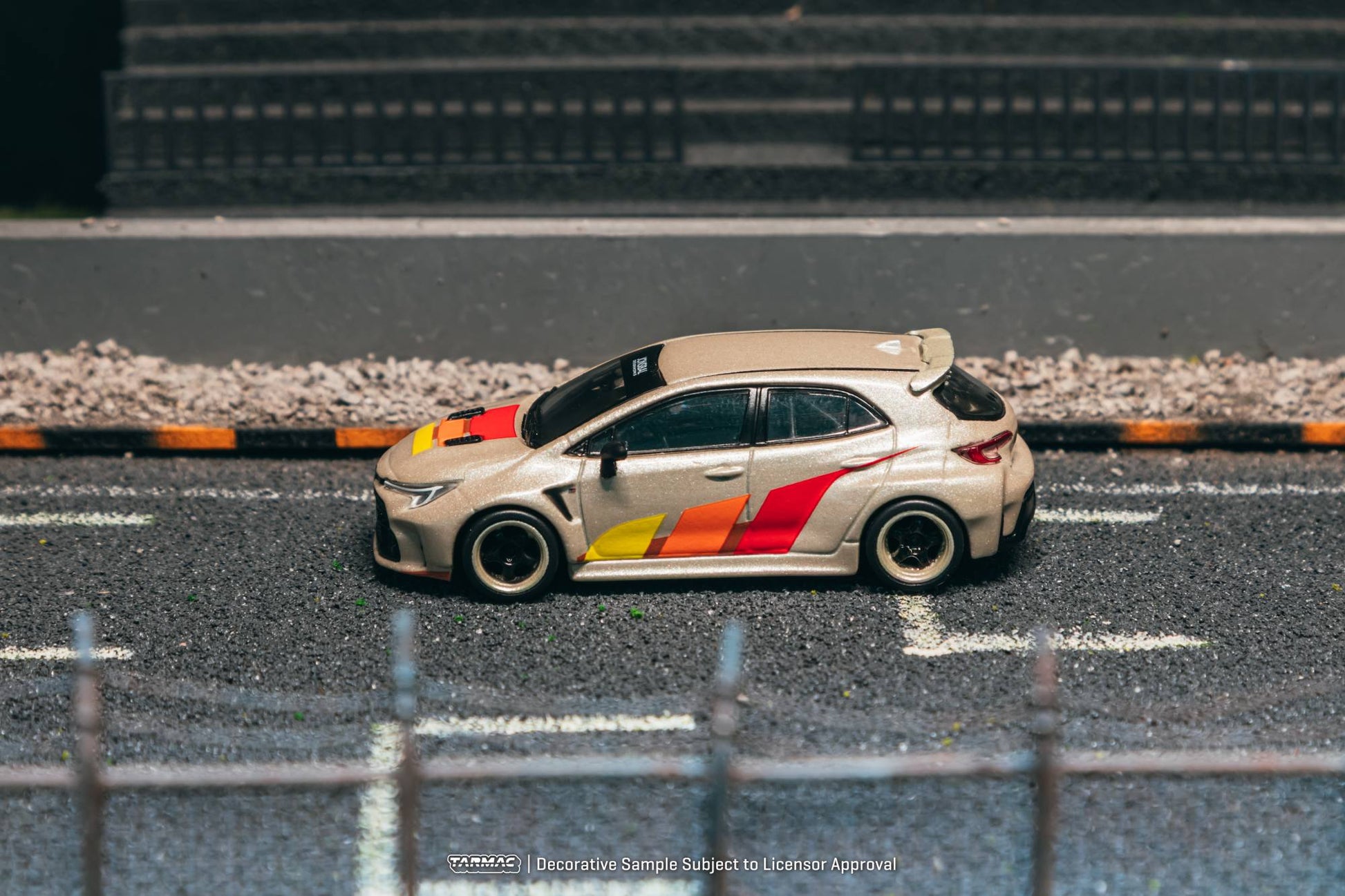 Tarmac Works 1:64 Toyota GR Corolla widebody beige Jon Sibal graphics diecast model. Side
