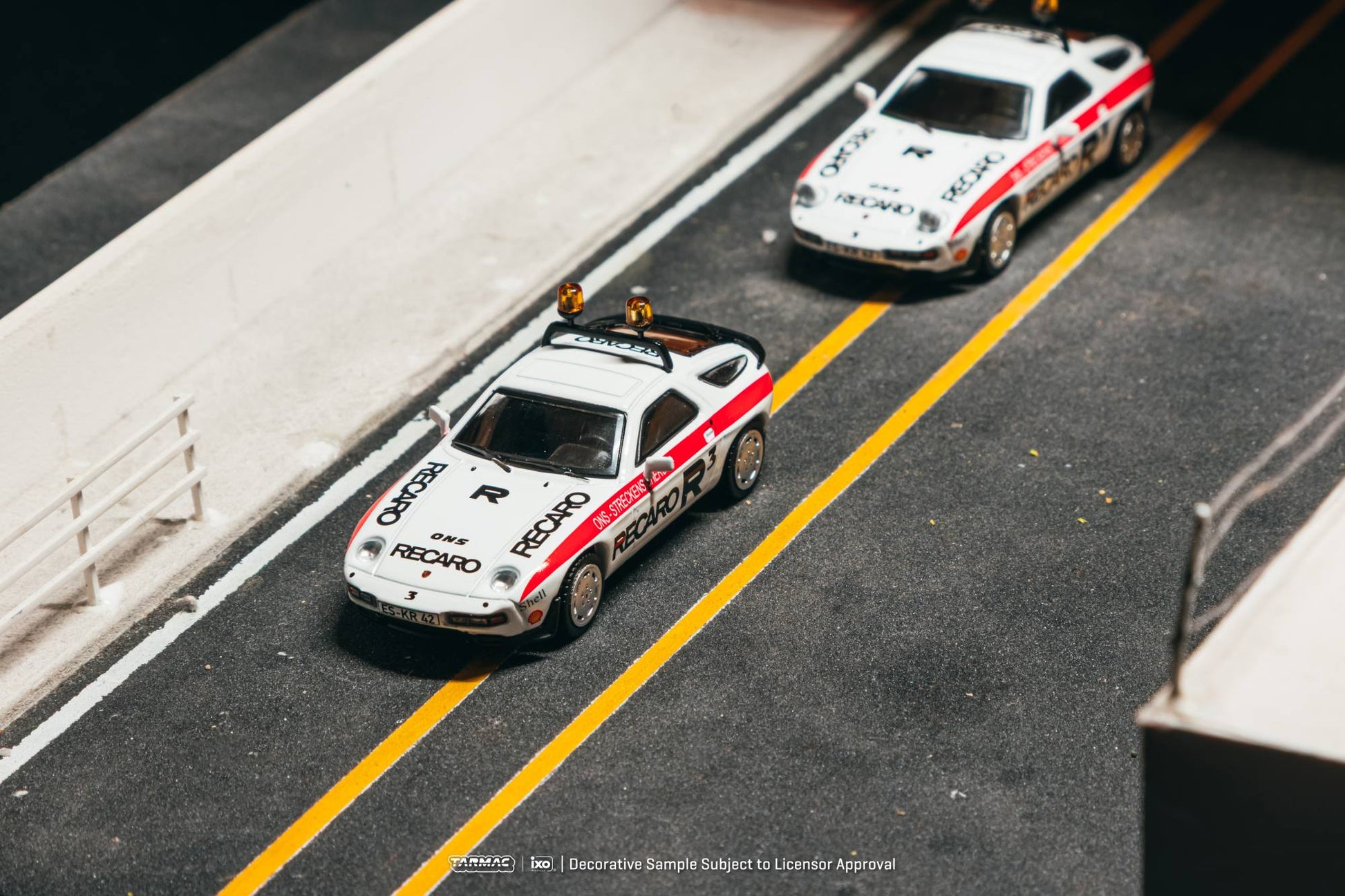 Tarmac Works 1:64 Porsche 928 S safety car white red ONS livery diecast model. Top