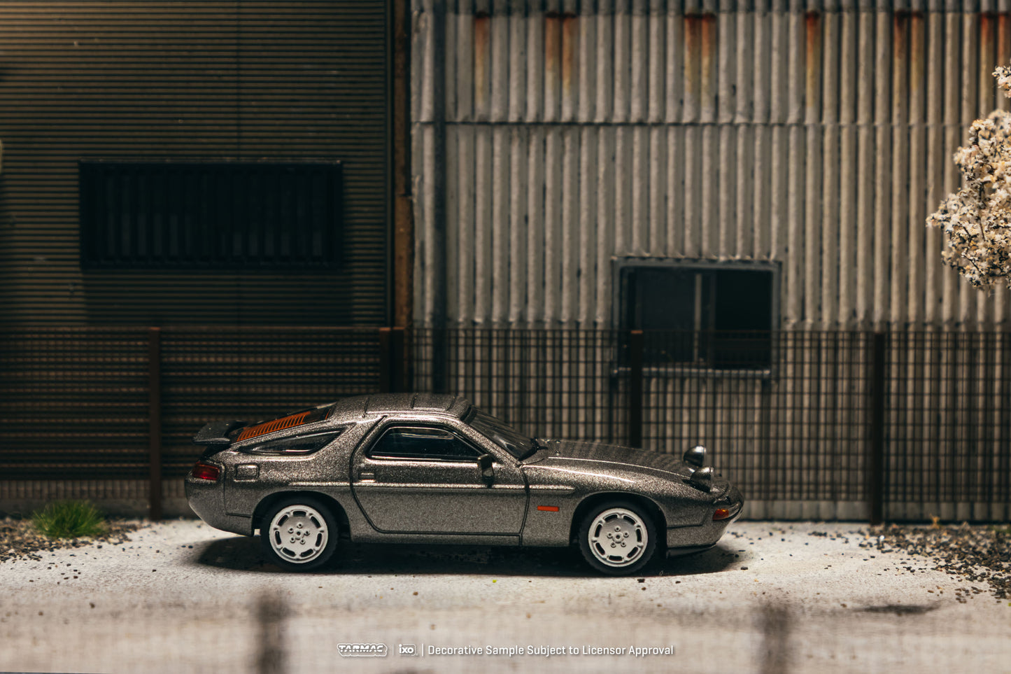 Tarmac Works Global64 Porsche 928 S4 in Grey Metallic with rolling wheels.