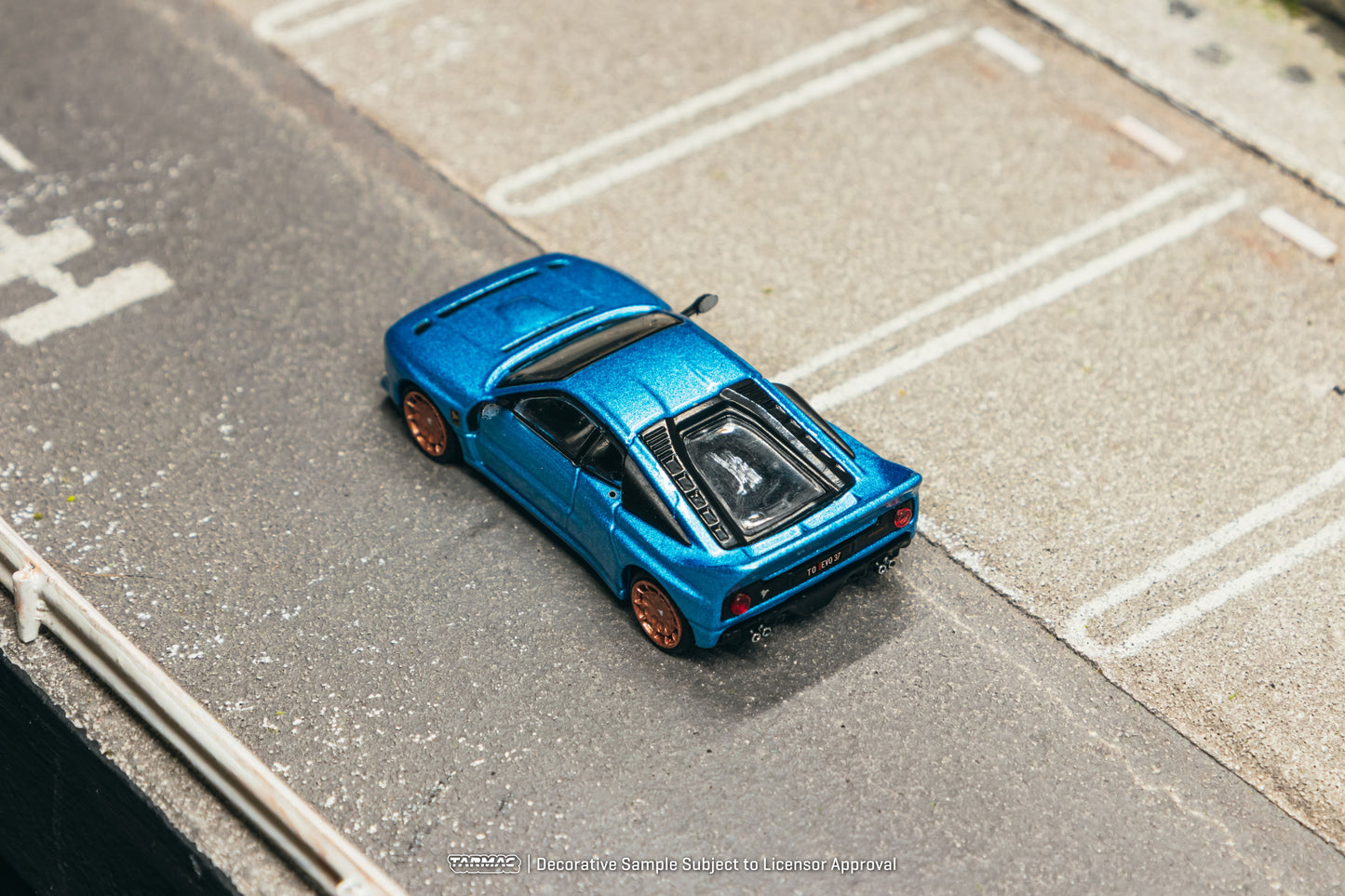 Tarmac Works Global64 Kimera EVO37 in blue with rolling wheels.
