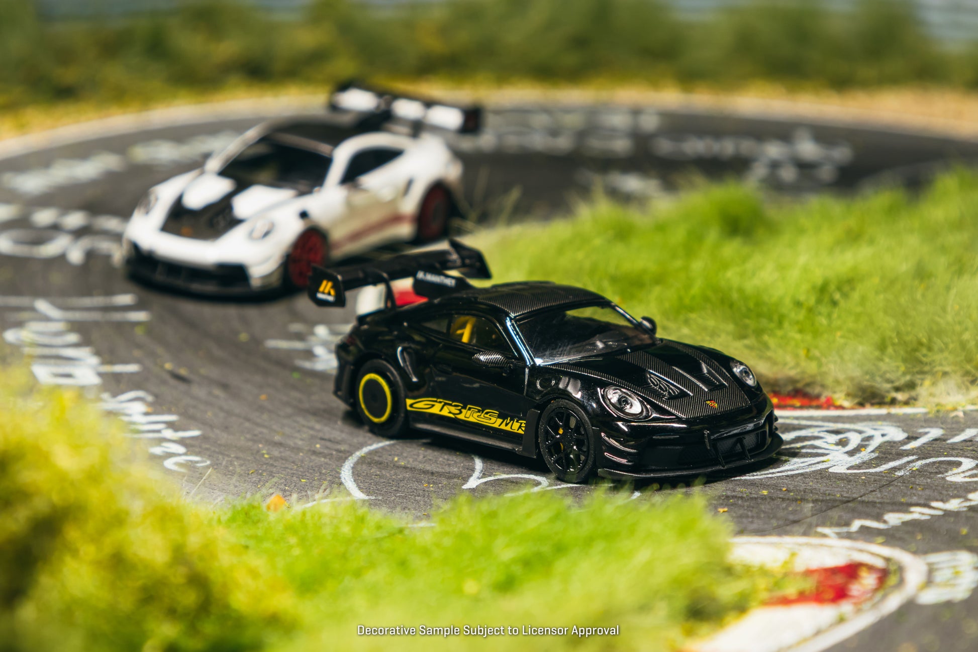 Tarmac Works Porsche 911 GT3 RS 992.1 MR in black and yellow from the Collab64 series. Front
