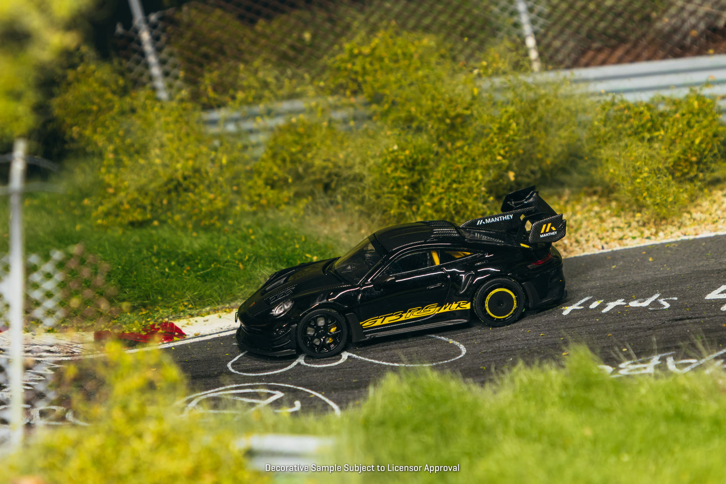 Tarmac Works Porsche 911 GT3 RS 992.1 MR in black and yellow from the Collab64 series. Side