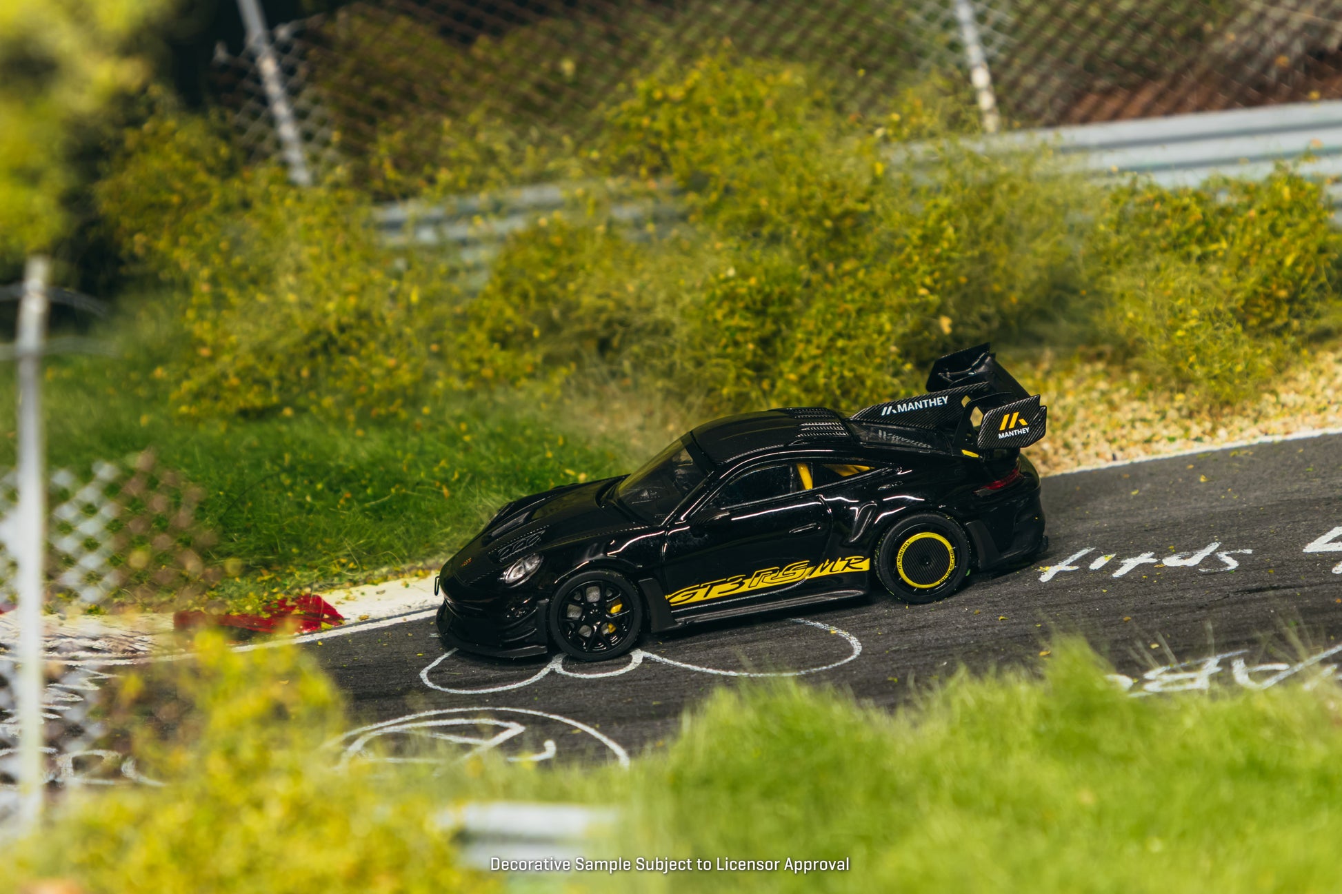 Tarmac Works Porsche 911 GT3 RS 992.1 MR in black and yellow from the Collab64 series. Side