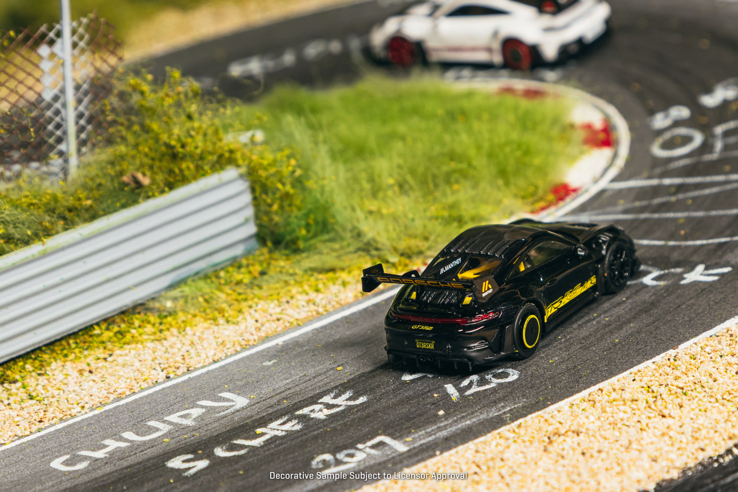 Tarmac Works Porsche 911 GT3 RS 992.1 MR in black and yellow from the Collab64 series. Back