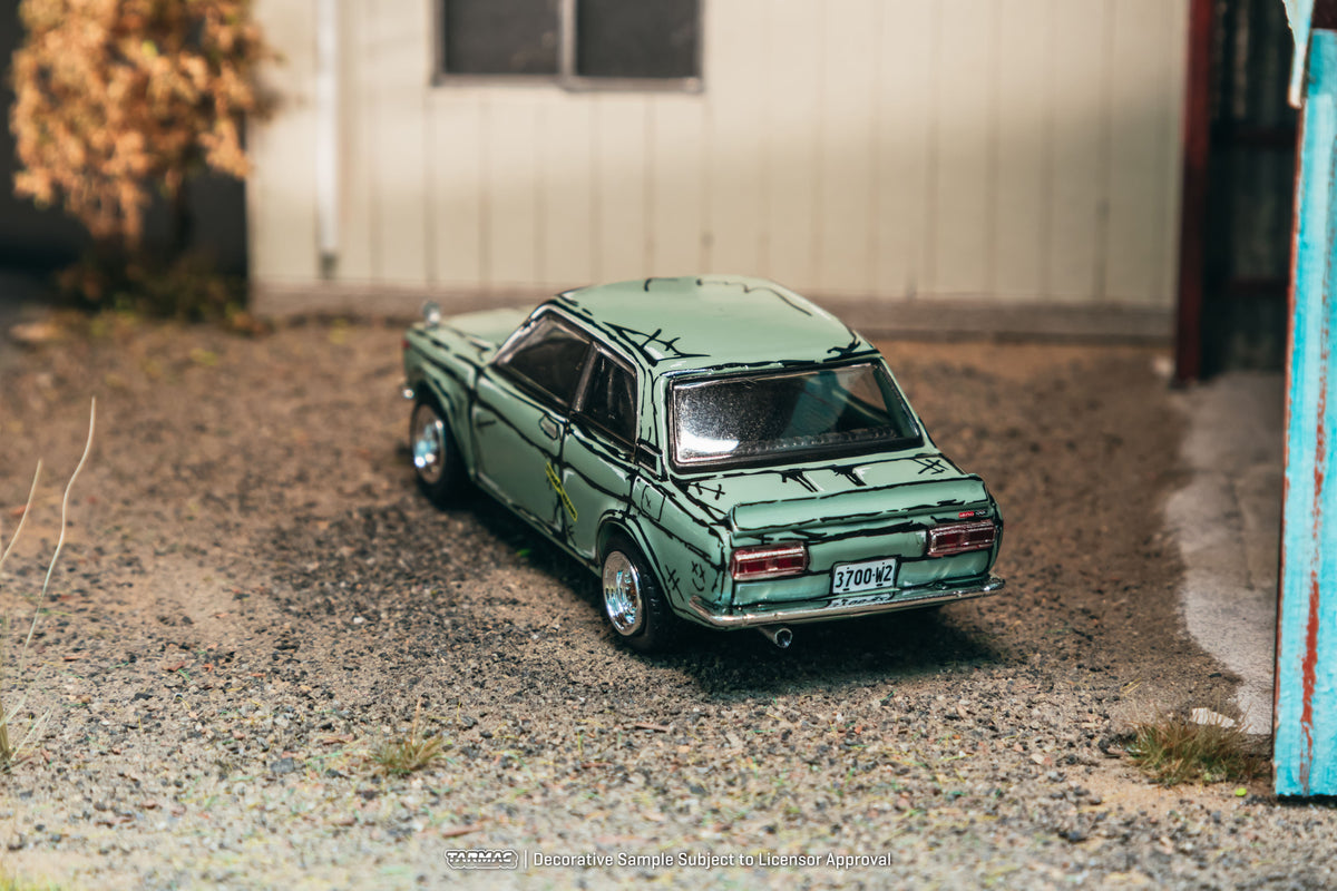 Tarmac Works 1973 Datsun 510 Bluebird Wagon SSS in green, a 1:64 Hobby64 diecast model in an acrylic display case.