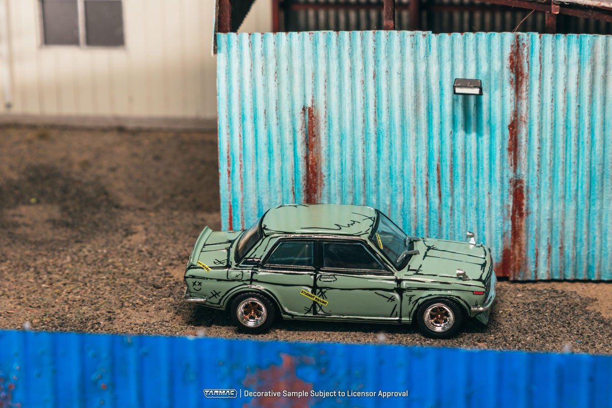 Tarmac Works 1973 Datsun 510 Bluebird Wagon SSS in green, a 1:64 Hobby64 diecast model in an acrylic display case.