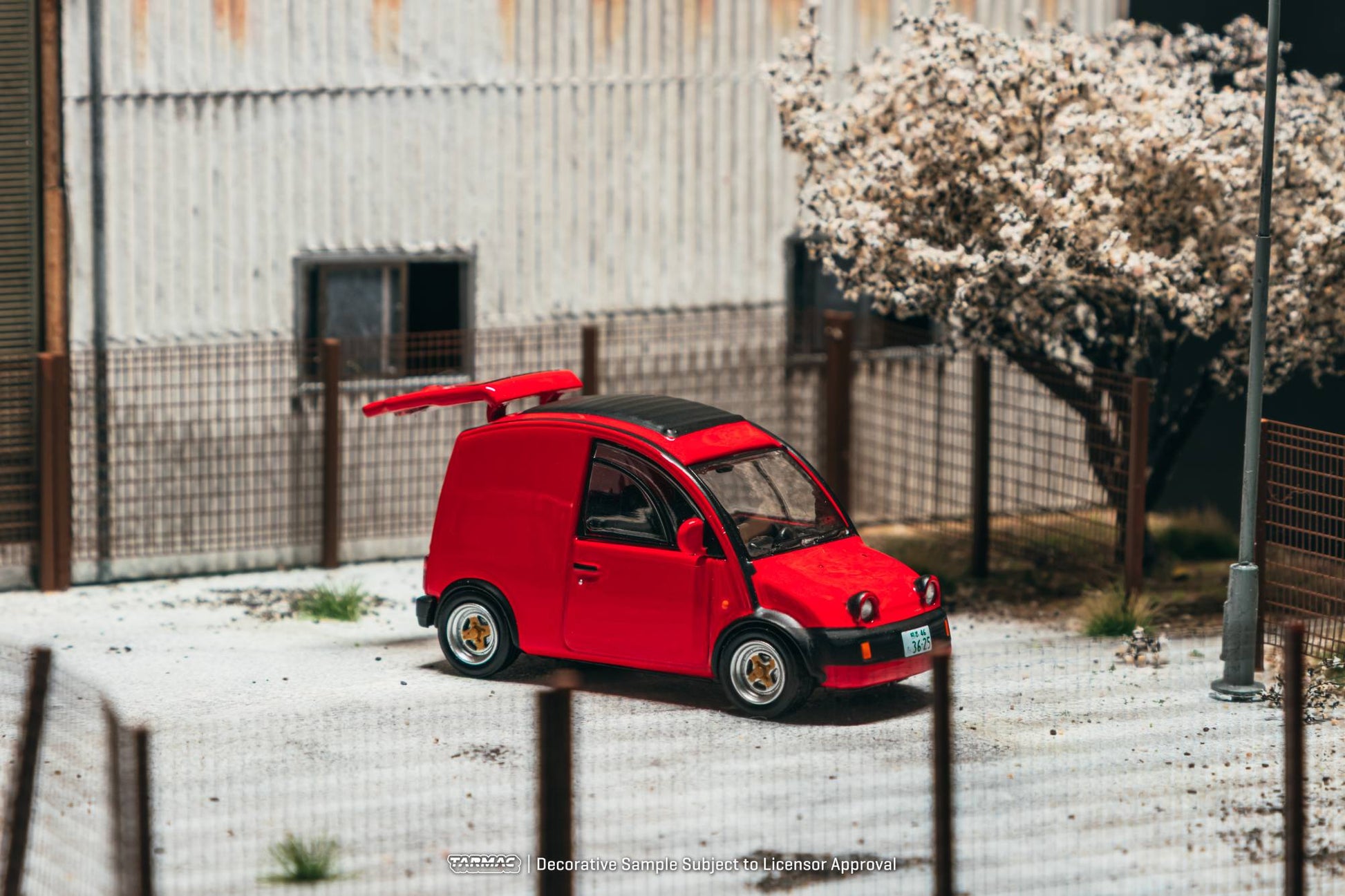Tarmac Works 1:64 Nissan S Cargo 1995 red diecast model with movable rear door. Front
