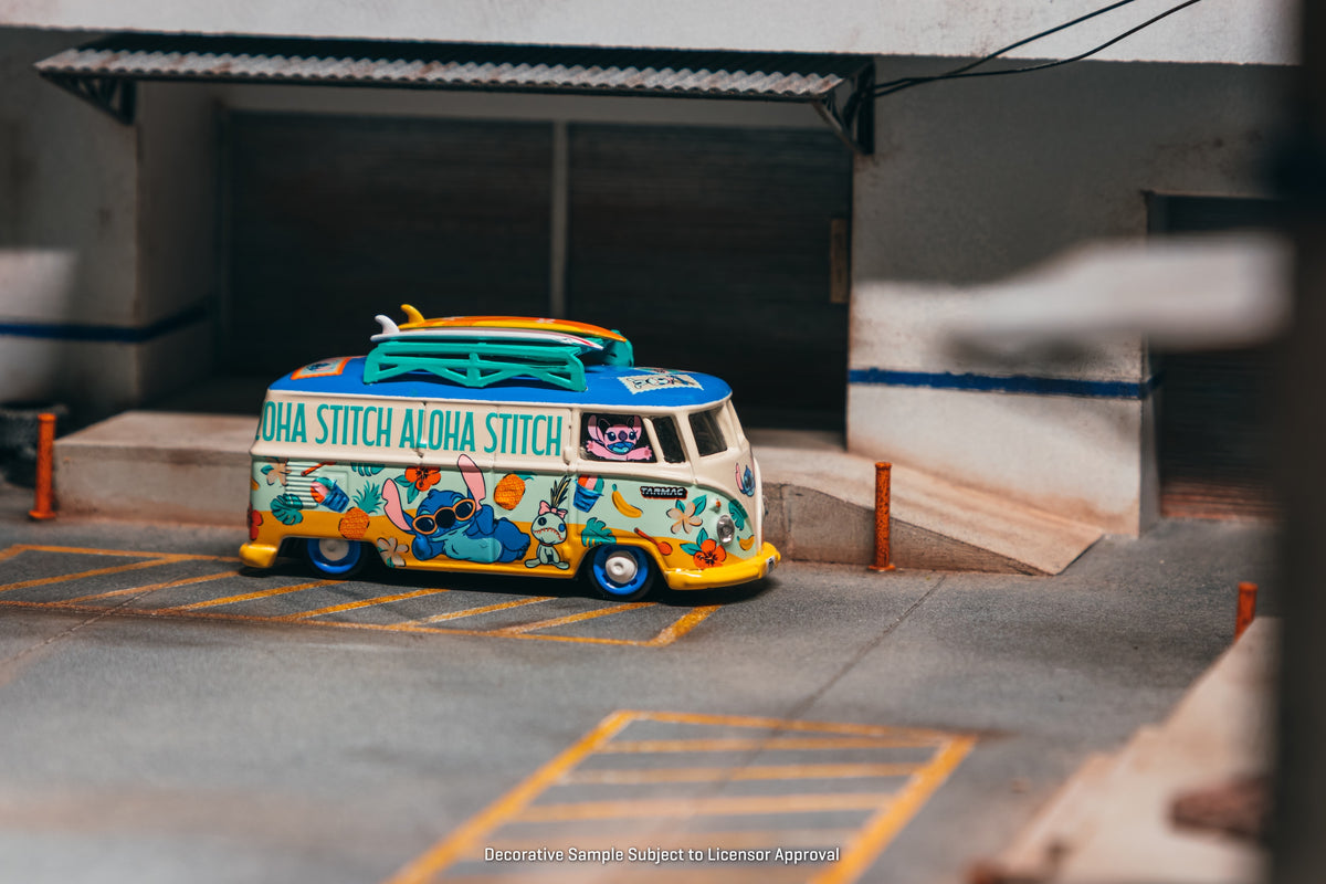 Tarmac Works 2025 Volkswagen Transporter T1 Panel Van Lilo & Stitch, a 1:64 Hobby64 model in an acrylic display case.