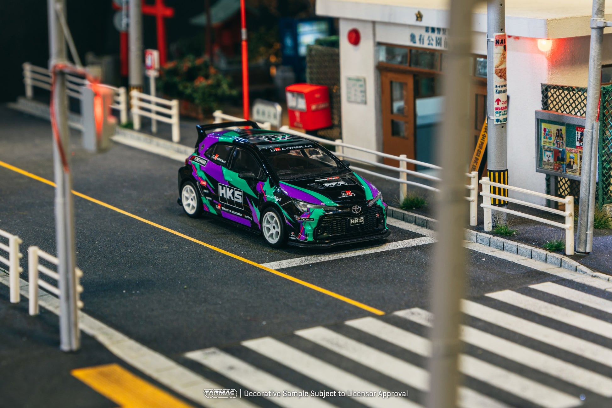1:64 scale Tarmac Works HKS Toyota GR Corolla with iconic oil splash livery and widebody styling.