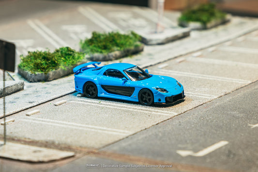 1:64 Tarmac Works Mazda RX-7 VeilSide Fortune7 in baby blue, widebody kit, VeilSide logos, detailed rims and headlights, pre-order collectible model. Front