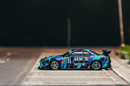 Tarmac Works 1:64 Nissan Skyline R32 Widebody HKS with trading cards diecast model. Side