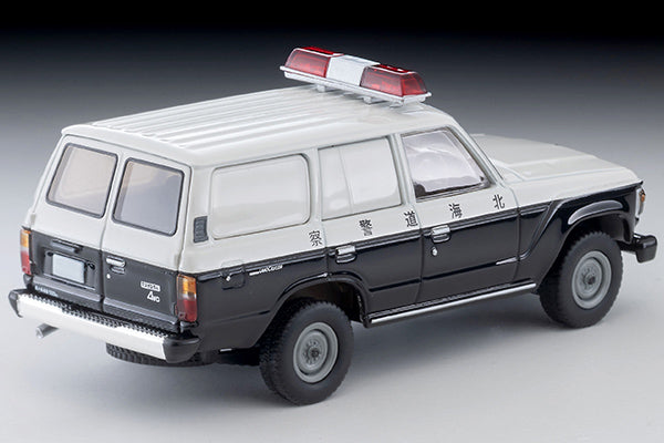 Tomica Limited Vintage Toyota Land Cruiser 60 Hokkaido Police patrol car with round headlights, red light and covered side windows.
