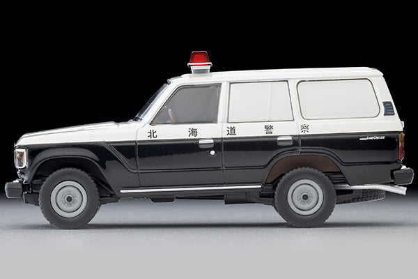 Tomica Limited Vintage Toyota Land Cruiser 60 Hokkaido Police patrol car with round headlights, red light and covered side windows.