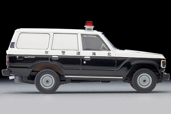 Tomica Limited Vintage Toyota Land Cruiser 60 Hokkaido Police patrol car with round headlights, red light and covered side windows.